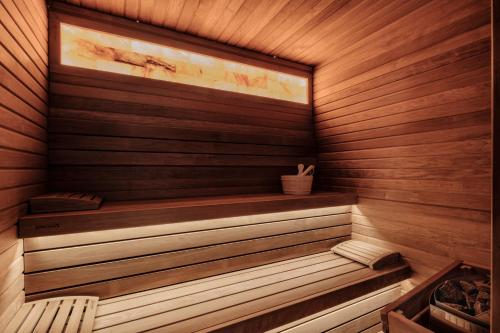 a wooden sauna with a bench in it at 1926 Les Bains Private Spa Suites in Sliema