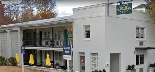 a white building with a sign on the side of it at Little Mod Hotel at the University in Charlottesville