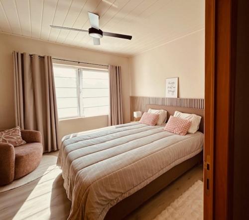 a bedroom with a large bed and a ceiling fan at Charmante woning in de Vlaamse Ardennen in Sint-Lievens-Houtem