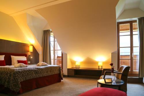 a hotel room with two beds and a window at Schlosshotel Kitzbühel in Kitzbühel