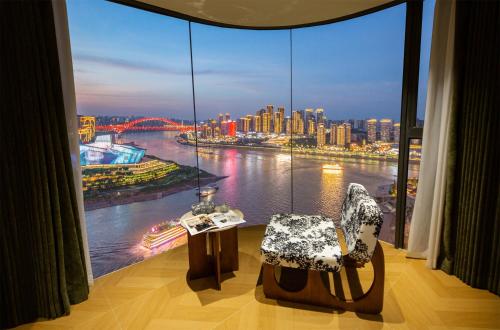 a room with a large window with a view of a river at Chongqing Shangshanzhu Riverside View Homestay in Chongqing
