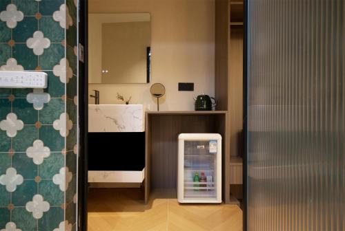 a small refrigerator in a kitchen next to a counter at Chongqing Shangshanzhu Riverside View Homestay in Chongqing