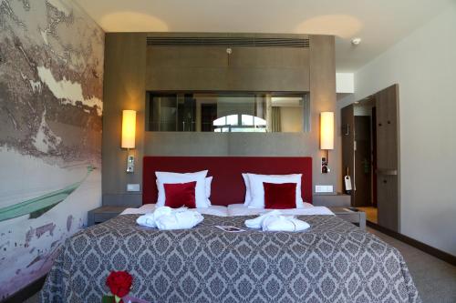 a bedroom with a large bed with two towels on it at Schlosshotel Kitzbühel in Kitzbühel