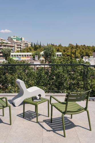 a group of chairs and a table and a white sculpture at Fits Living in Athens