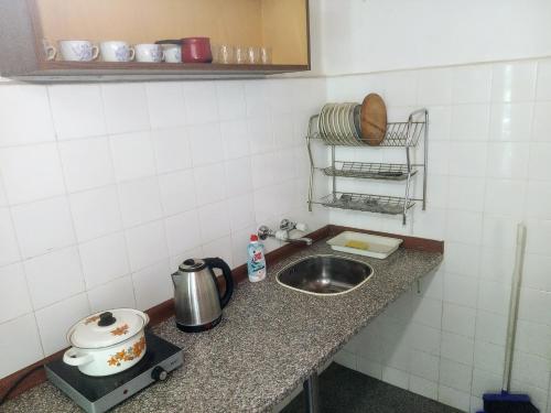 a kitchen counter top with a sink and a counter top at Holiday Home Tanevi in Tryavna