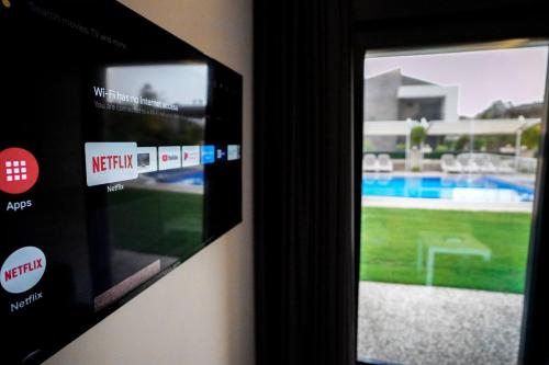 a television with a view of a swimming pool at Camyuva Beach Hotel in Kemer