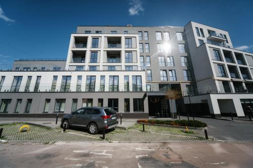 a car parked in front of a large building at Select Hotel in Lviv