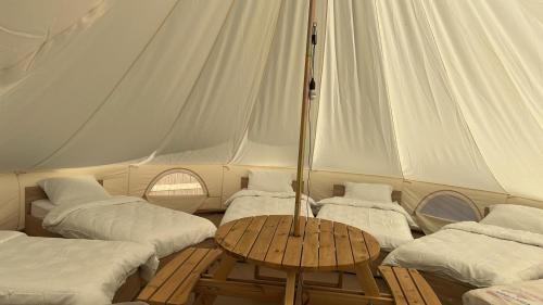 a tent with four beds and a table in it at Casa Alexia in Potoc