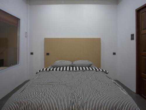 a black and white striped bed in a room at 88 Fine Hotel @ Suratthani Airport in Surat Thani