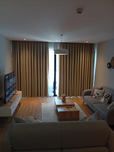 a living room with a couch and a tv at Exclusive Residence Famagusta in Famagusta