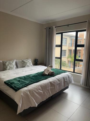 a bedroom with a large bed and a large window at The Hideaway at The Palms in Kimberley