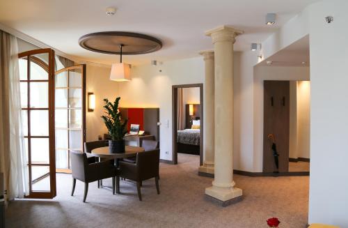 a room with a table and chairs and a bedroom at Schlosshotel Kitzbühel in Kitzbühel