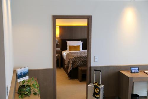 a hotel room with a bed and a door leading to a bedroom at Schlosshotel Kitzbühel in Kitzbühel