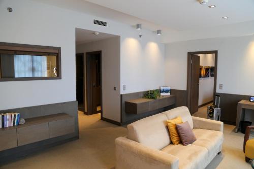 a living room with a couch and a mirror at Schlosshotel Kitzbühel in Kitzbühel