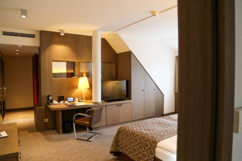 a hotel room with a desk and a bed at Schlosshotel Kitzbühel in Kitzbühel