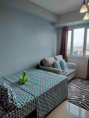 a bedroom with a bed with bananas on it at Cozy Studio Unit in Quezon City with Private Pool and City Views in Manila