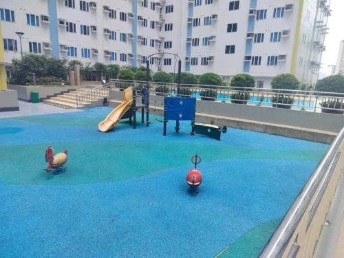 a playground with a slide at Cozy Studio Unit in Quezon City with Private Pool and City Views in Manila