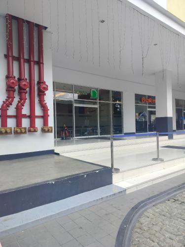 a store front with red columns in a building at Cozy Studio Unit in Quezon City with Private Pool and City Views in Manila