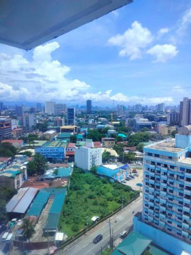 a view of a city from a building at Modern Condo in Quezon City with Private Pool and City Views in Manila