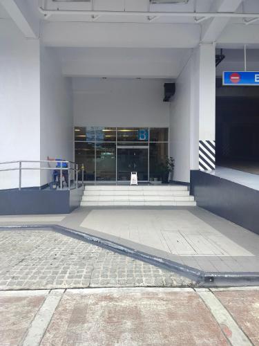 an empty lobby of a building with a sign at Modern Condo in Quezon City with Private Pool and City Views in Manila