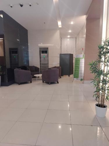 a lobby with couches and a table in a building at Luxurious 9th Floor Studio in Quezon City with Private Pool in Manila