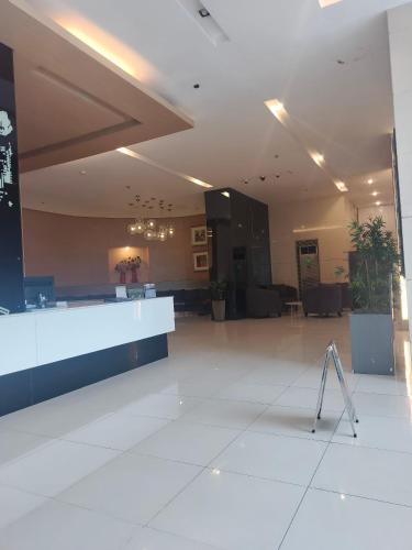 a lobby with a reception desk in a building at Luxurious 9th Floor Studio in Quezon City with Private Pool in Manila