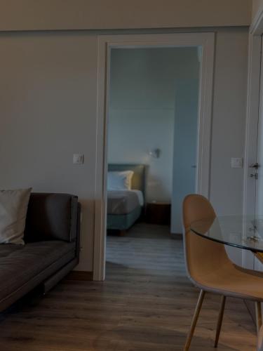 a living room with a couch and a glass table at Valtes Luxurious Apartment III in Mpoukaris