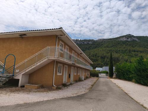a building with a staircase on the side of it at Residella hôtel in Gémenos