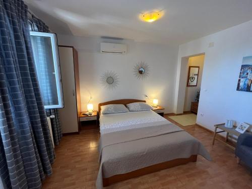 a bedroom with two beds and a window at Apartments Nevenka i Josko in Tučepi
