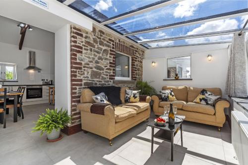 a conservatory living room with a glass ceiling at Cysgod Y Ffordd - a gorgeous new barn conversion sleeping 4 guests with disabled facilities in Carmarthen