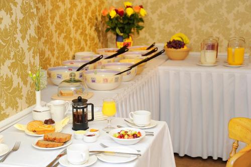 a white table with a buffet of food on it at Ashville House in Killarney
