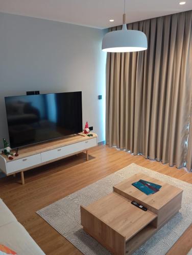 a living room with a large flat screen tv at Elegant Residence Famagusta in Famagusta