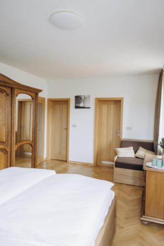 a bedroom with a large white bed and a couch at FamilyVilla, new 4 Luxury Big Apartments, parking in Prague