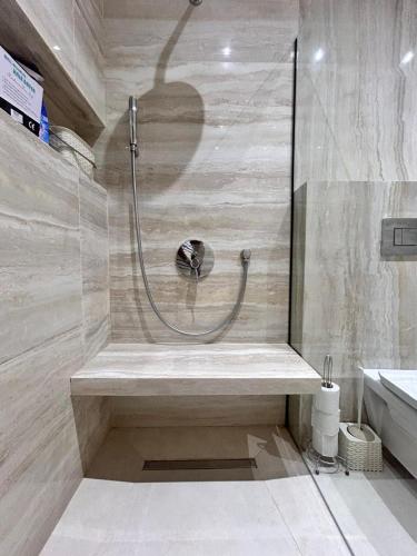 a shower with a bench in a bathroom at Villa SUN SQUARE DJERBA in Awlād ‘Umar