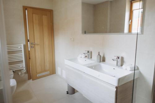 a white bathroom with a sink and a toilet at FamilyVilla, new 4 Luxury Big Apartments, parking in Prague