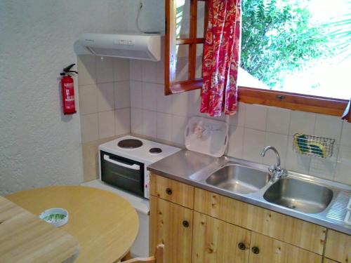 a small kitchen with a sink and a stove at Akrata Golden Beach House in Aíyira