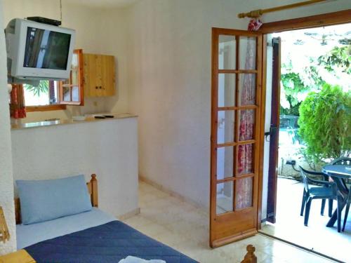 a living room with a door open to a patio at Akrata Golden Beach House in Aíyira