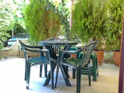 two chairs and a table and two tables and chairs at Akrata Golden Beach House in Aíyira