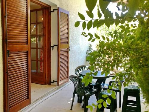 a table and chairs in front of a door at Akrata Golden Beach House in Aíyira