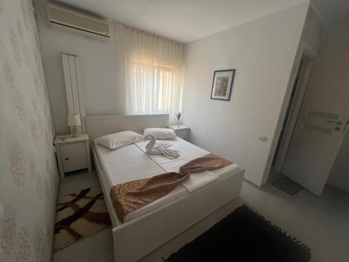 a white bedroom with a bed in a room at Emmaia Escape Eforie Nord in Eforie Nord
