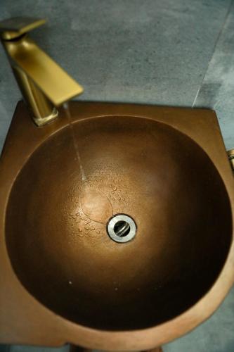 a wooden sink with a faucet in a bathroom at Eco Bliss Hotel in Thôn Lại Thê