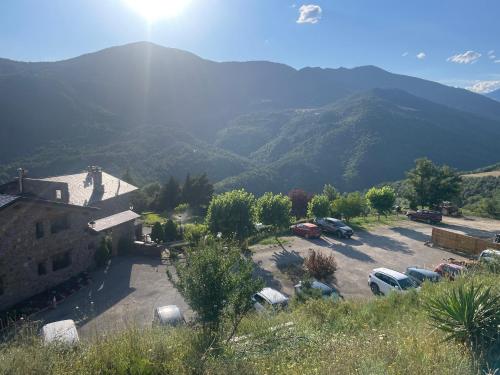 a view of a parking lot with mountains in the background at Les Flors - Hotel Rural & Cabanyes in Gramós