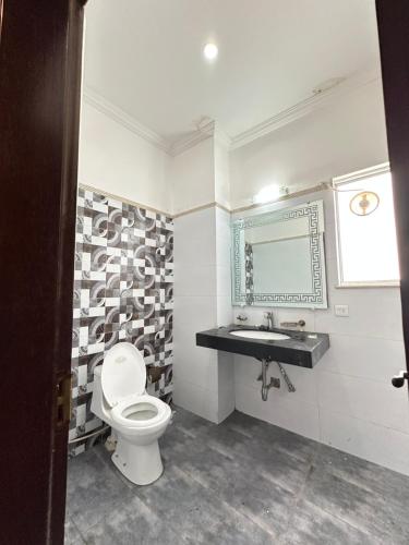 a bathroom with a toilet and a sink at Bahria Oasis G Floor Portion in BTK in Karachi