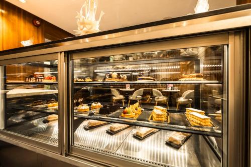 a display case in a bakery with cakes and bread at The President Hotel Cairo in Cairo