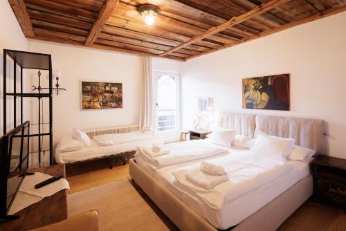 a bedroom with a large white bed in a room at Appartements Greier in Telfes im Stubai