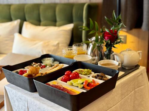 two trays of food sitting on a table at SCHUSTER Boarding House in Braşov