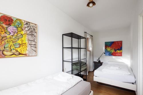 a room with a bed and a painting on the wall at Appartements Greier in Telfes im Stubai