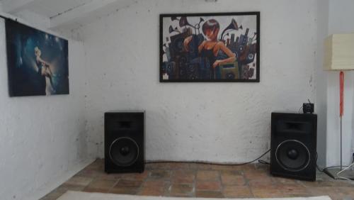 a room with two speakers and a painting on the wall at Antica Acetaia in Carpaneto Piacentino