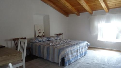 a bedroom with a bed and a table and a window at Antica Acetaia in Carpaneto Piacentino