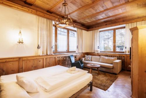 a living room with a bed and a couch at Appartements Greier in Telfes im Stubai